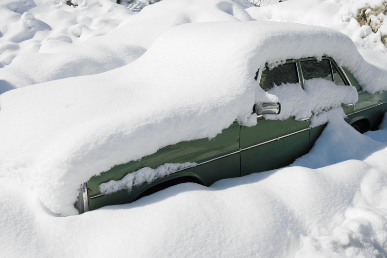 Car buried in snow.